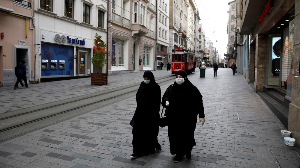 Women wearing protective face masks and gloves are seen as the spread of the coronavirus disease (COVID-19) continues, Istanbul, Turkey, March 26, 2020. REUTERS/Umit Bektas