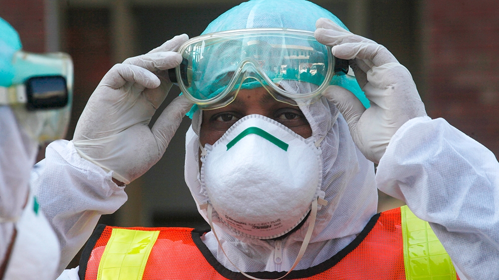 A Pakistani health personnel takes part in a drill exercise as a preventative measures during an emergency of coronavirus outbreak, in Peshawar Pakistan, Monday, March 3, 2020. Pakistani health offici