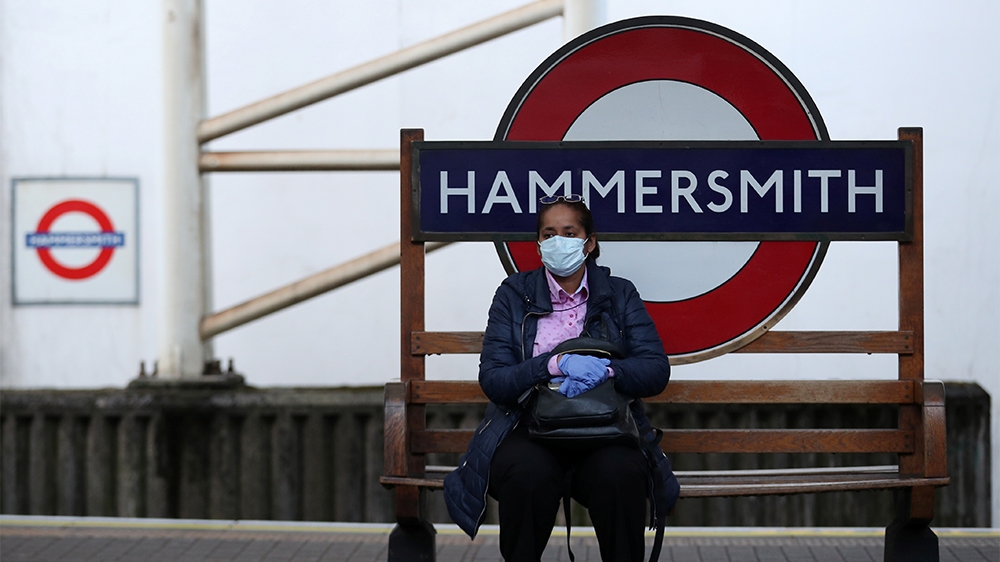 A commuter wearing a protective face mask at Hammersmith underground station as the spread of the coronavirus disease (COVID-19) continues, London, Britain, March 24, 2020. REUTERS/Hannah McKay