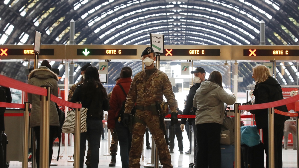 Police officers and soldiers check passengers leaving from Milan main train station, Italy, Monday, March 9, 2020. Italy took a page from China''s playbook Sunday, attempting to lock down 16 million pe