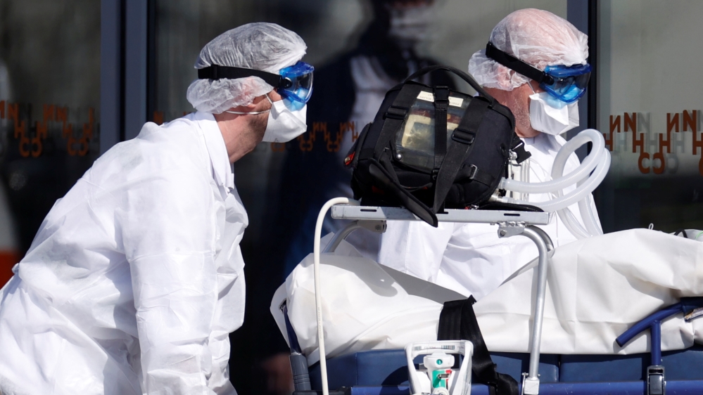 French SMUR rescue team wearing protective suits carry a patient at Strasbourg University hospital