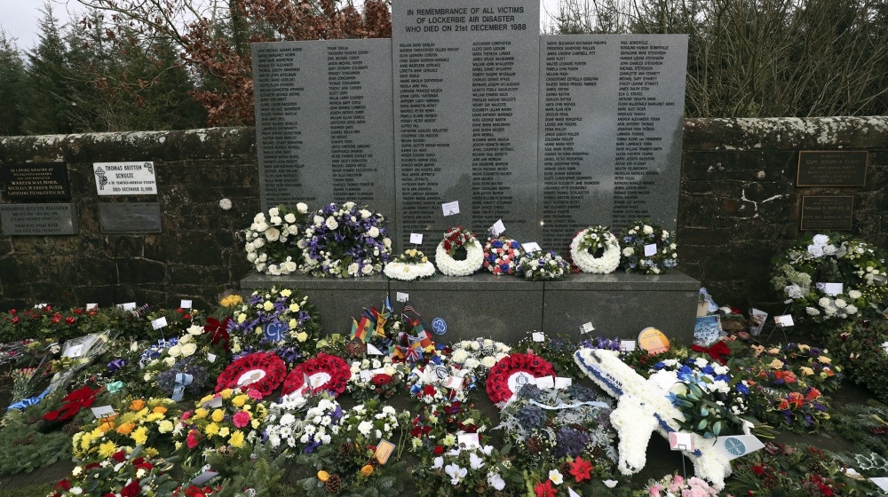 A general view of floral tributes which have been laid by the main memorial stone in memory of the victims of Pan Am flight 103 bombing, in the garden of remembrance at Dryfesdale Cemetery, near Locke