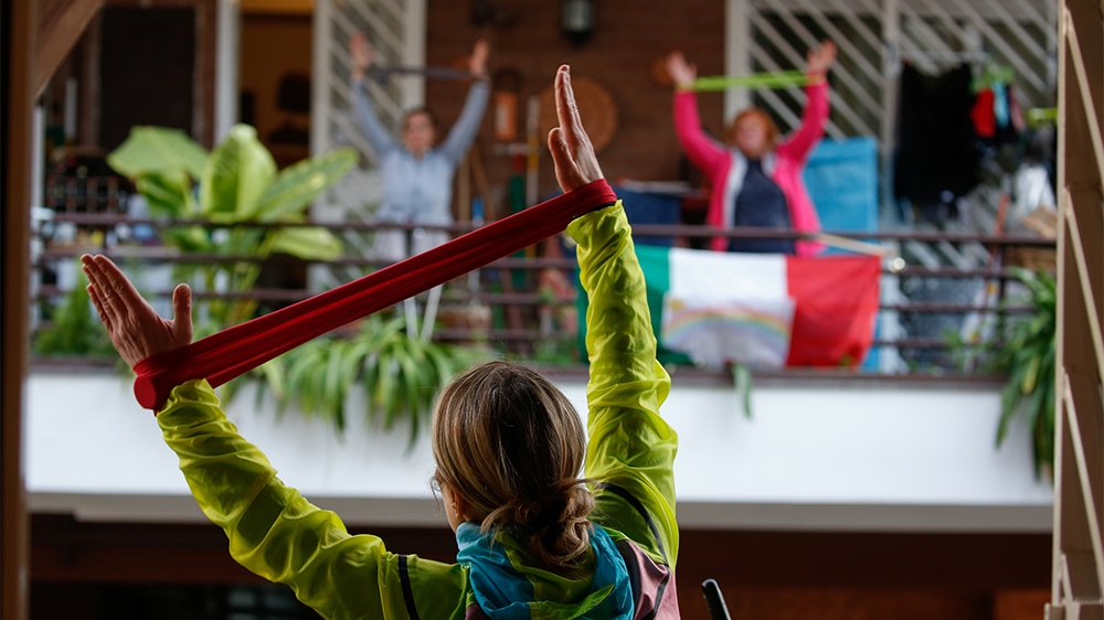 Personal trainer Antonietta Orsini carries out an exercise class for her neighbours from her balcony while Italians cannot leave their homes due to the coronavirus disease (COVID-19) outbreak, in Rome