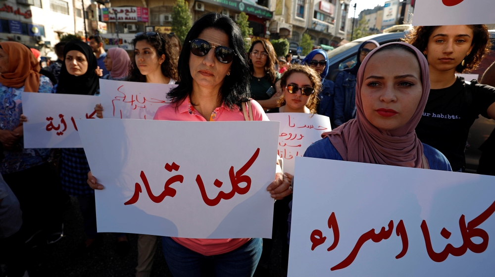Demonstrators hold signs during a protest demanding legal protection for women, in Ramallah in the Israeli-occupied West Bank September 4, 2019. REUTERS/Mohamad Torokman