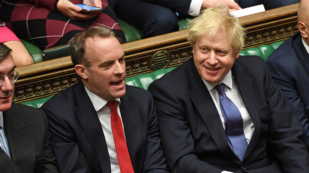A handout photograph released by the UK Parliament shows Britain''s Prime Minister Boris Johnson (C) smiling beside (L-R) Britain''s Leader of the House of Commons J