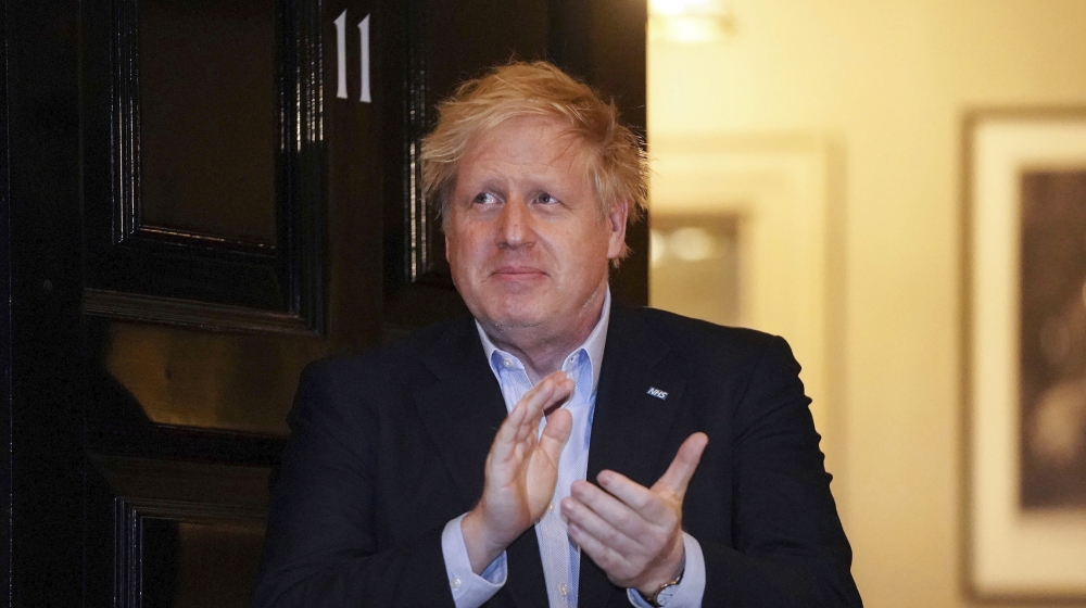 In this handout photo provided by 10 Downing Street, Britain''s Prime Minister Boris Johnson claps outside 11 Downing Street to salute local heroes during Thursday''s nationwide Clap for Carers NHS in
