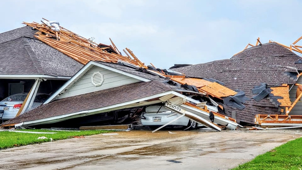 Damaged buildings and vehicles are seen in the aftermath of a tornado in Monroe, Louisiana, U.S. April 12, 2020, in this still image obtained from social media. Courtesy of Peter Tuberville/Social Med