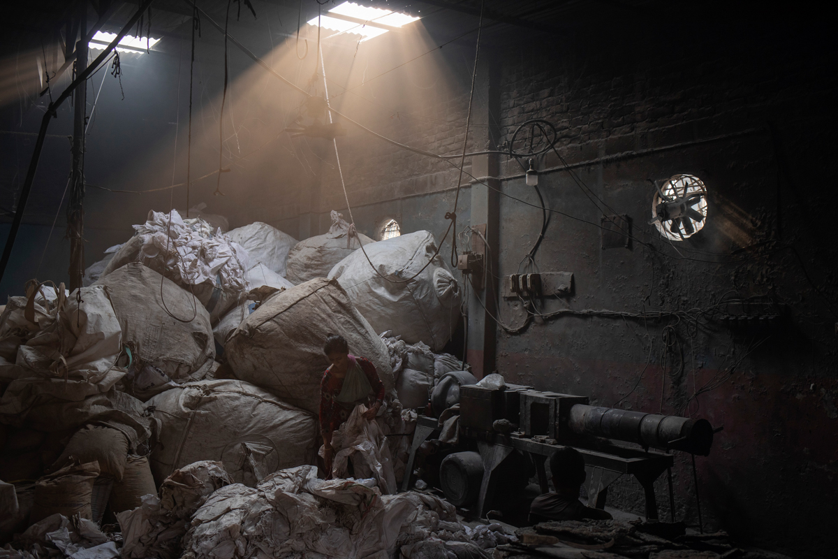 Monora, 45, sorts out plastic sacks to burn for recycling in Dhaka, Bangladesh, April 27, 2019. She has five children and has been working in this job for the last ten years. She said she knows that s