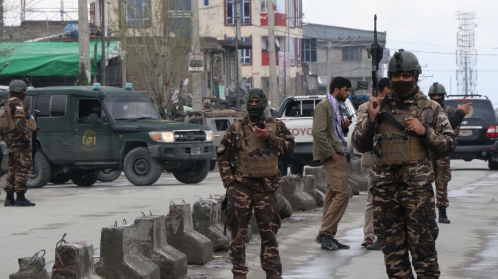 Afghan security personnel stand guard near the site of an attack to a Sikh temple in Kabul on March 25, 2020. The Islamic State group has claimed an attack on a Sikh-Hindu temple