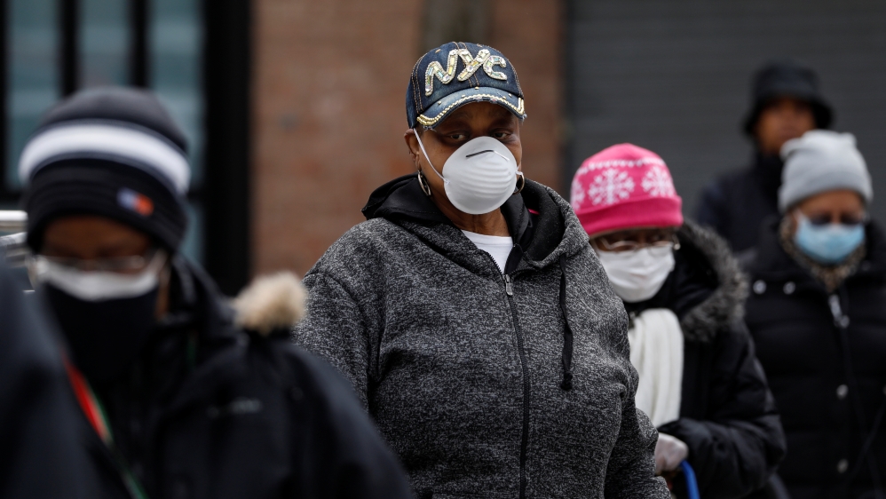 People wait in line for donated food distribution at the Queensbridge Houses, a NYCHA public housing complex, during the outbreak of the coronavirus disease (COVID-19) in New York