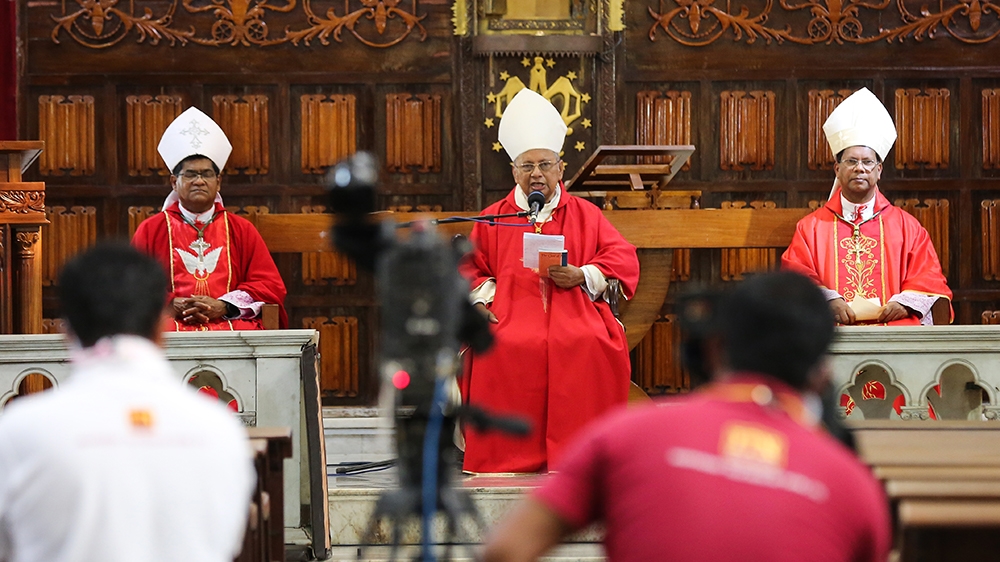 epa08355762 Archbishop of Colombo Cardinal Malcolm Ranjith (C) holds an online Good Friday service at the almost deserted all Saints church†during an island-wide curfew,†in Colombo, Sri Lanka, 10 Apri