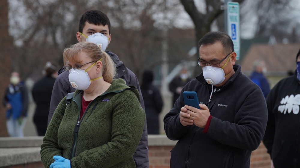 Voters wearing protective