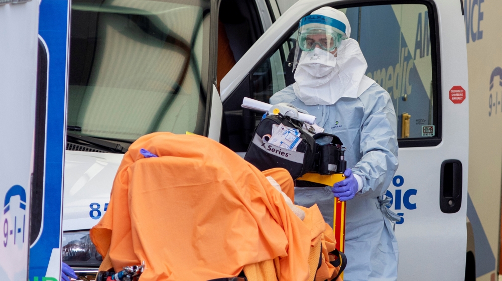 A paramedic transports a patient to Mount Sinai Hospital as the number of the coronavirus disease (COVID-19) cases continue to grow in Toronto, Ontario, Canada April 17, 2020. REUTERS/Carlos Osorio