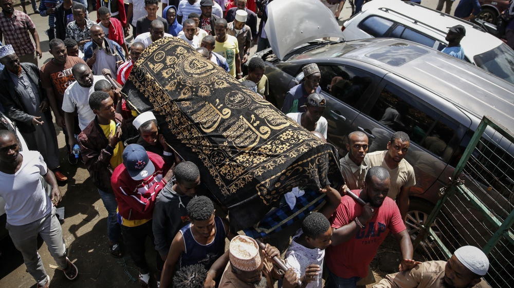 Relatives carry the body of 13-year-old Yasin Hussein Moyo for burial, at the Kariakor cemetery in Nairobi, Kenya Tuesday, March 31, 2020. The family of a 13-year-old boy is in mourning after police i