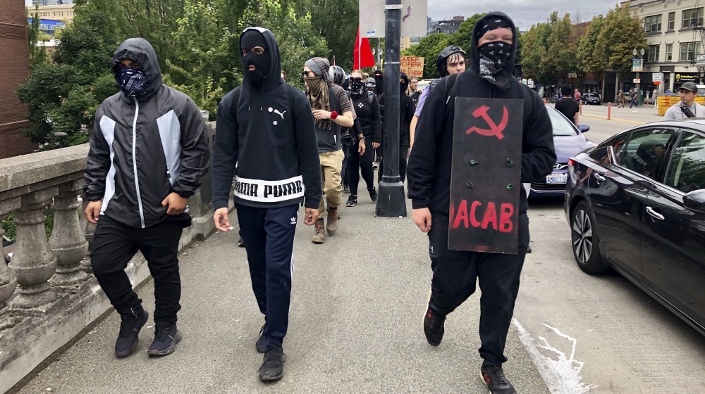 Anti-fascist counter-demonstrators cross the Burnside Bridge across the Willamette River from the west side of the city to the east side in search of the far-right group, the Proud Boys, in Portland,