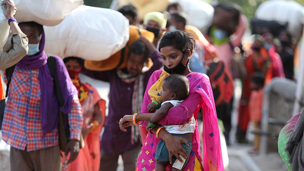 Migrant workers from other states trying to return to their homes arrives outside at train station in Jammu, India, Friday, May.22, 2020.(AP Photo/Channi Anand)
