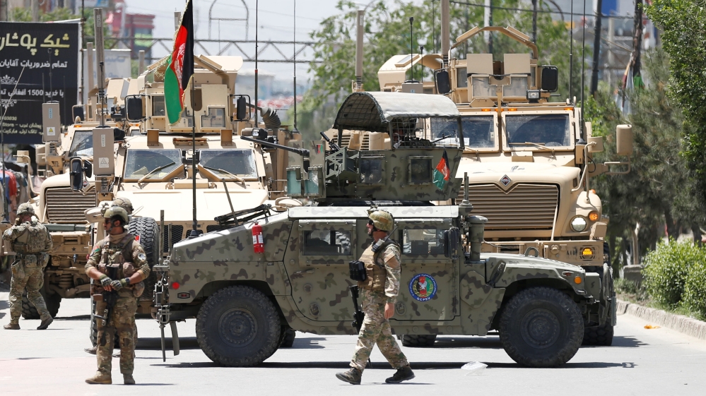 Afghan security forces stand guard outside a hospital which came under attack in Kabul