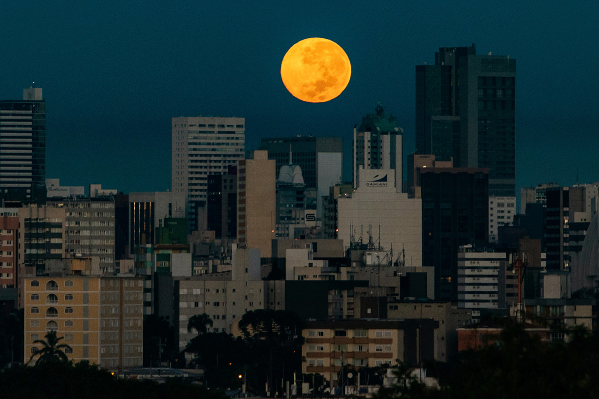 The Flower Supermoon rises over Curitiba, Brazil on May 7, 2020. The supermoon is visible as the full moon coincides with the satellite in its closest approach to Earth, which makes it appear brighter