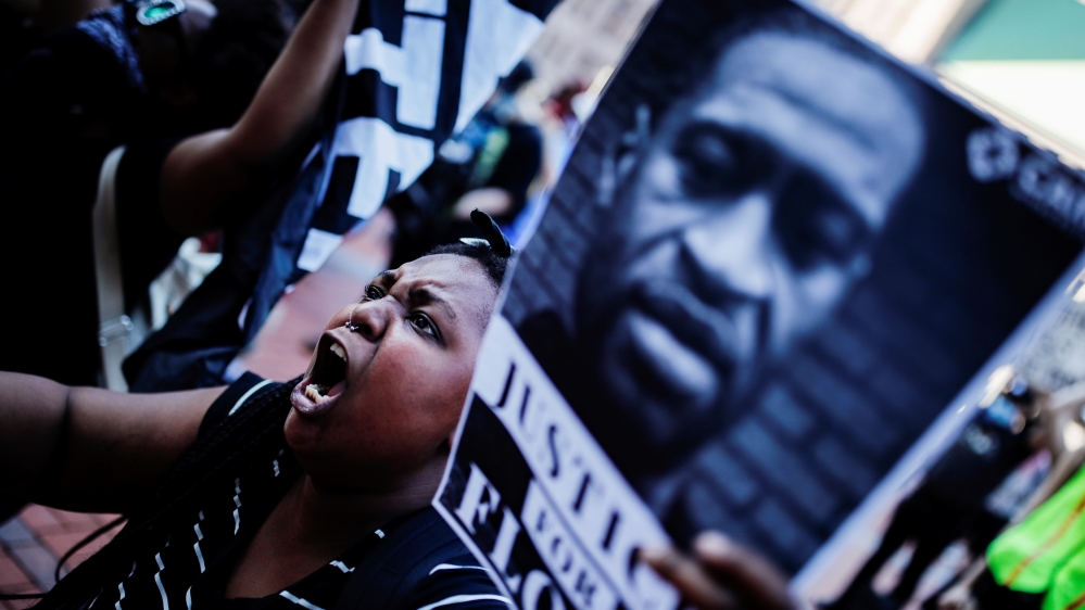 A protester reacts while gathering with others outside the city hall in Minneapolis