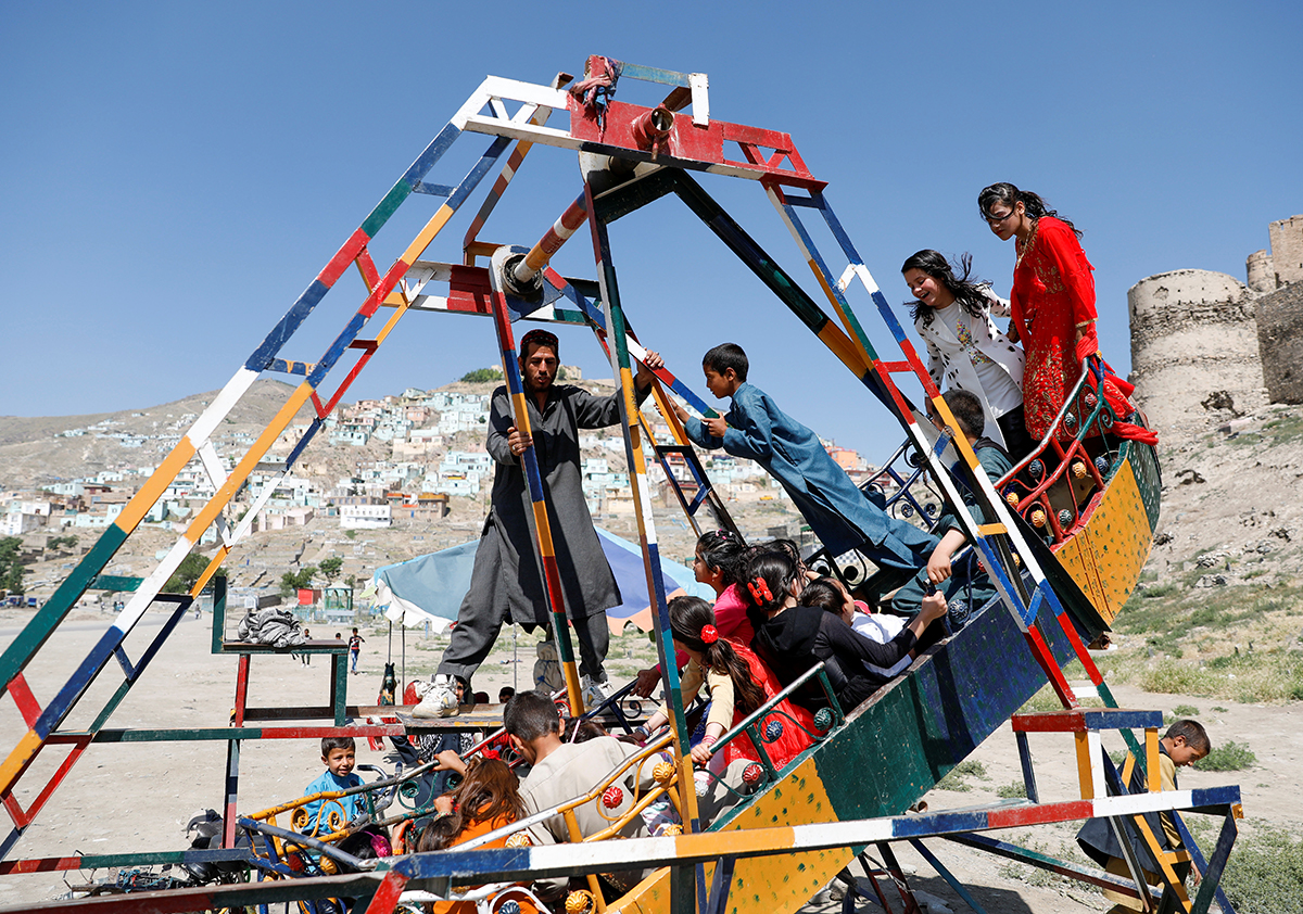 Children play during Eid al-Fitr, a Muslim festival marking the end the holy fasting month of Ramadan, at a mosque, amid the spread of the coronavirus disease (COVID-19), in Kabul, Afghanistan May 24,