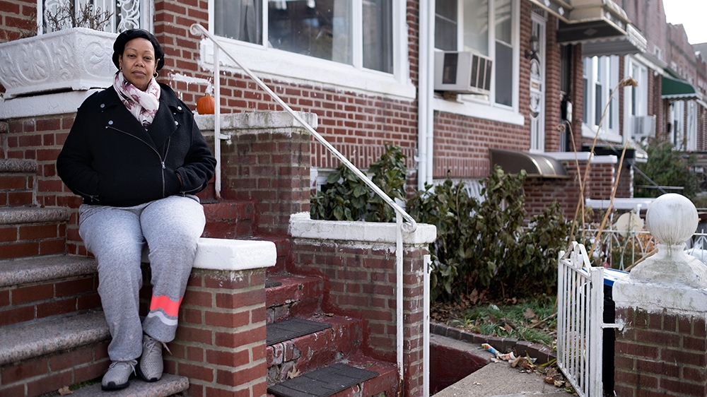 Still Here - Leah front stoop [Sara Bennett/Al Jazeera]