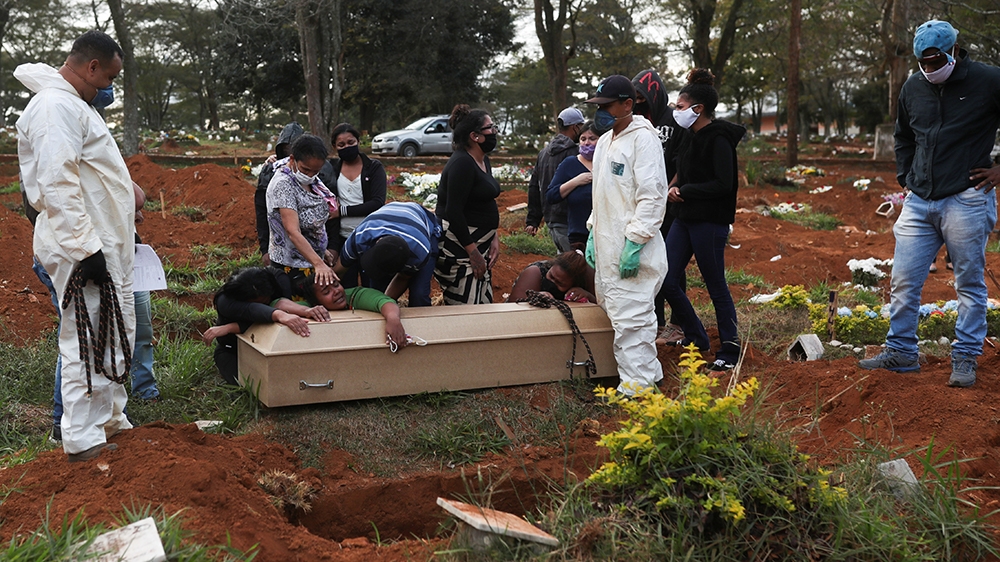 Relatives react during the burial of 64-year-old Raimunda Conceicao Souza, who died from the coronavirus disease (COVID-19), at Vila Formosa cemetery, Brazil''s biggest cemetery, in Sao Paulo, Brazil
