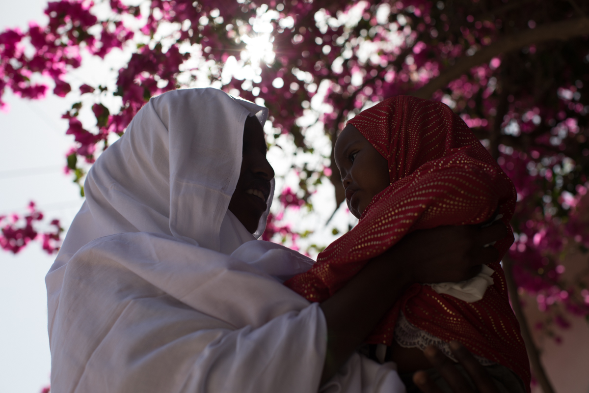 Fadmou holds her baby girl as she waits in a clinic in Hargeisa, Somaliland. The 18-year-old Ethiopian and her husband plan to migrate to Yemen and then to the Gulf in search of a better life. “Lif
