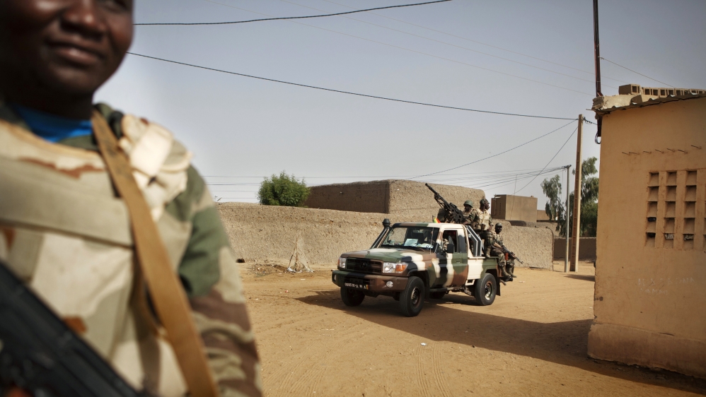 Soldiers from the Waraba Battalion ride in military vehicles in Gao