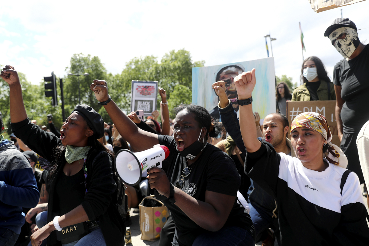 Demonstrators raise their fists during a Black Lives Matter protest following the death of George Floyd in Minneapolis police custody, in London, Britain, June 13, 2020. REUTERS/Simon Dawson