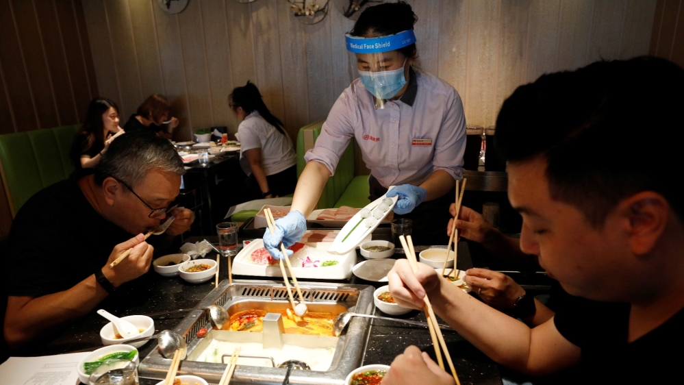 People eat at a busy steamboat restaurant in Singapore as the city state reopens the economy amid the coronavirus disease (COVID-19) outbreak