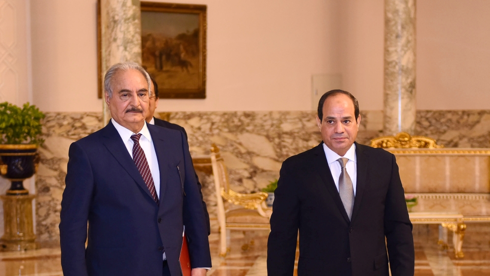 Libyan military commander Khalifa Haftar walks with Egyptian President Abdel Fattah al-Sisi at the Presidential Palace in Cairo