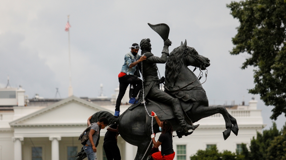Protestors attach a chain to the statue of U.S. President Andrew Jackson in front of the White House in an attempt to pull it down in Washington