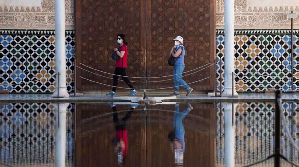 epa08490308 The first visitors walk at Alhambra Palace that has reopened in Granada, Spain, 17 June 2020, with a 50 percent of its capacity and 4,250 tickets per day. The visit has some itinerary mod