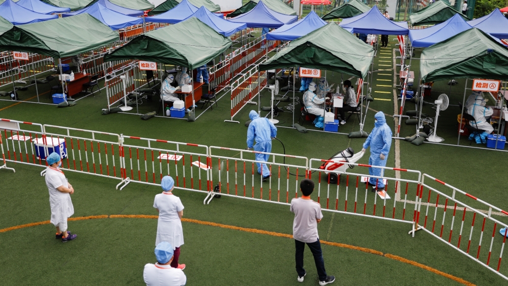 People receive nucleic acid tests, during a government-organised visit to a testing site, following a new outbreak of the coronavirus disease (COVID-19) in Beijing
