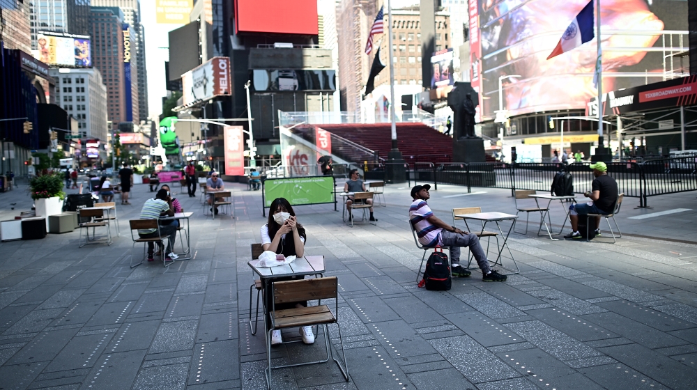 People sit on tables , respecting social distancing at Times Square as New York City enters phase two of reopening June 22, 2020. New York City begins phase two reopening on June 22, 2020 as people ca