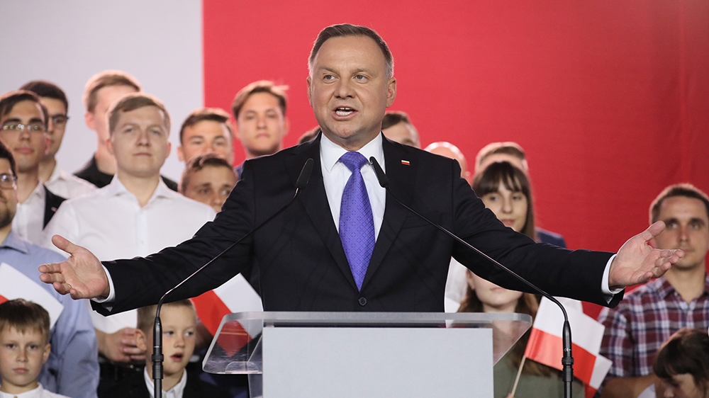 Polish President Andrzej Duda speaking at a podium.