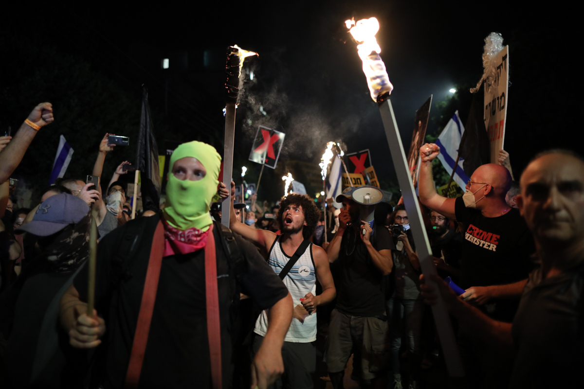 epa08546264 People protest against Israeli prime minister Benjamin Netanyahu corruption charges, outside his residence in Jerusalem, Israel, 14 July 2020. Netanyahu face an ongoing trail with indictme