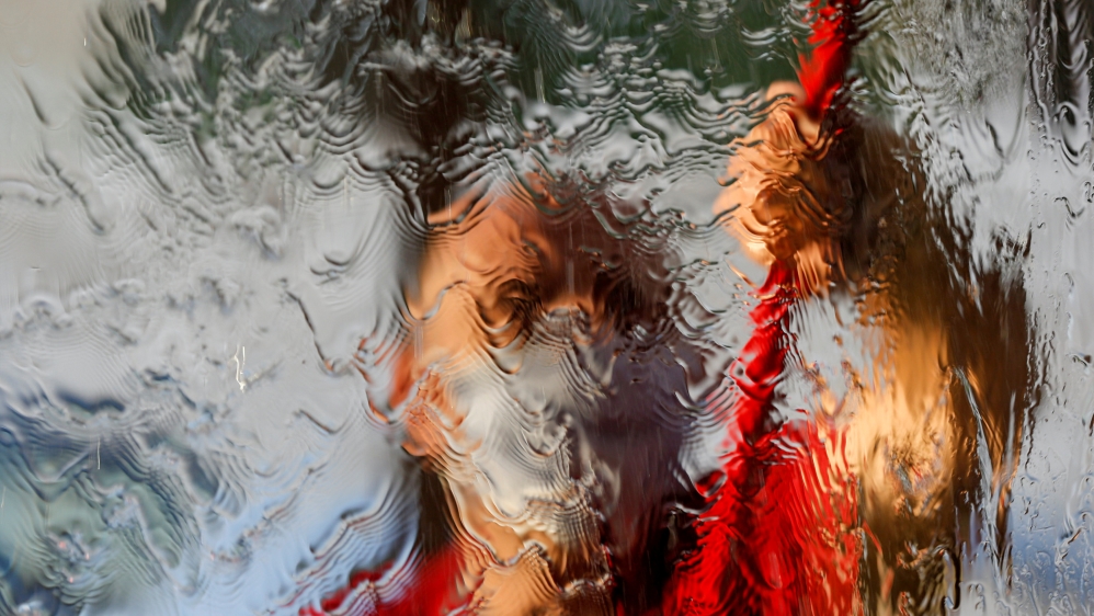 A worker cleans a window of a cafe before reopening it to the public for the first time since the start of the coronavirus disease (COVID-19) restrictions in Amman