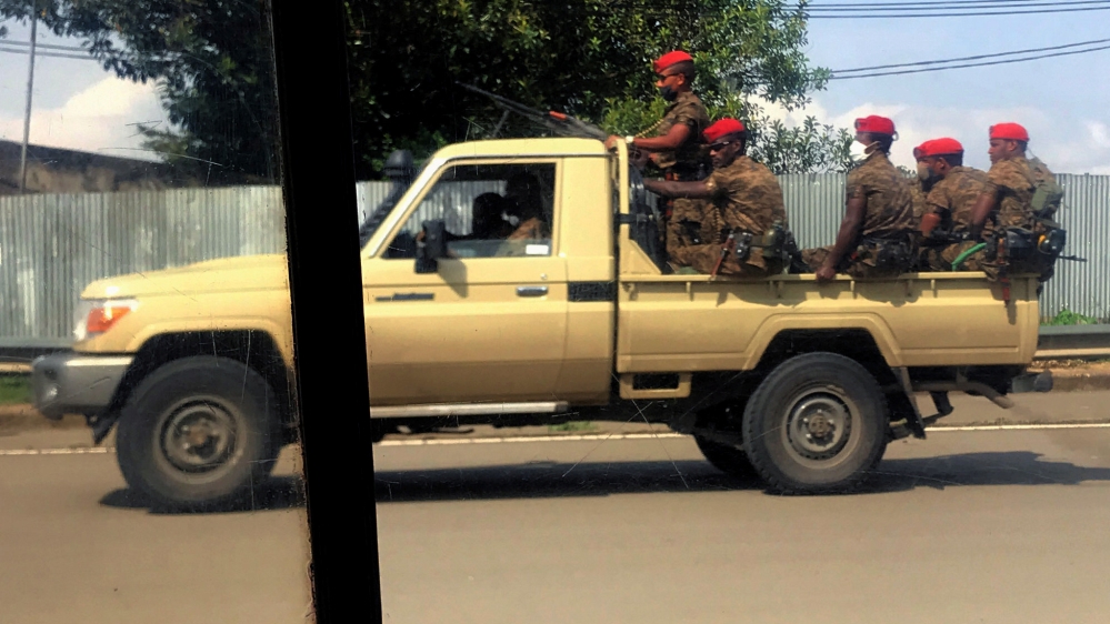 Ethiopian military ride on their pick-up truck as they patrol the streets following protests in Addis Ababa