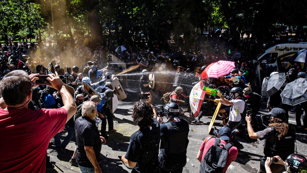Protesters and counter-protesters face off against one another in Portland, Oregon, U.S., August 22, 2020. REUTERS/Maranie Staab
