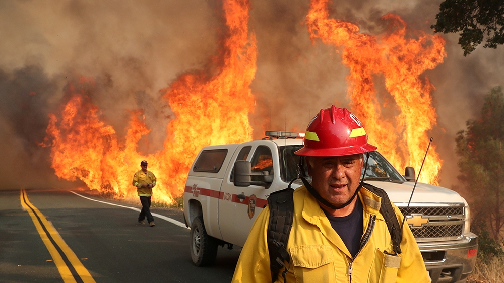 Chula Vista firefighter Rudy Diaz monitors the LNU Lightning Complex Fire as it engulfs brush in Lake County, California, U.S. August 23, 2020. REUTERS/Adrees Latif TPX IMAGES OF THE DAY