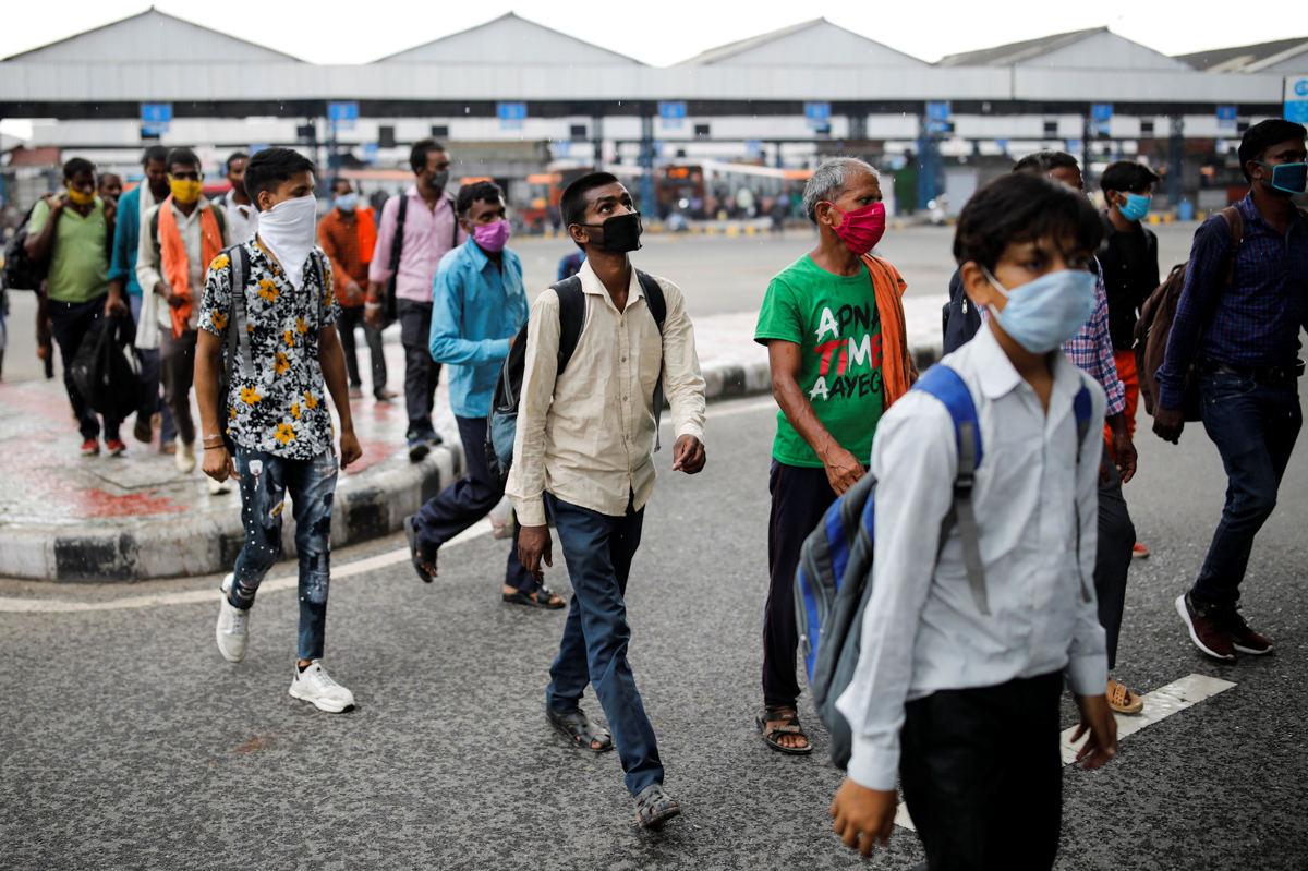 Migrant workers, who returned to Delhi from their native state arrive for a rapid antigen test, at a bus terminal, amidst the coronavirus disease (COVID-19) outbreak in New Delhi, India, August 17, 20