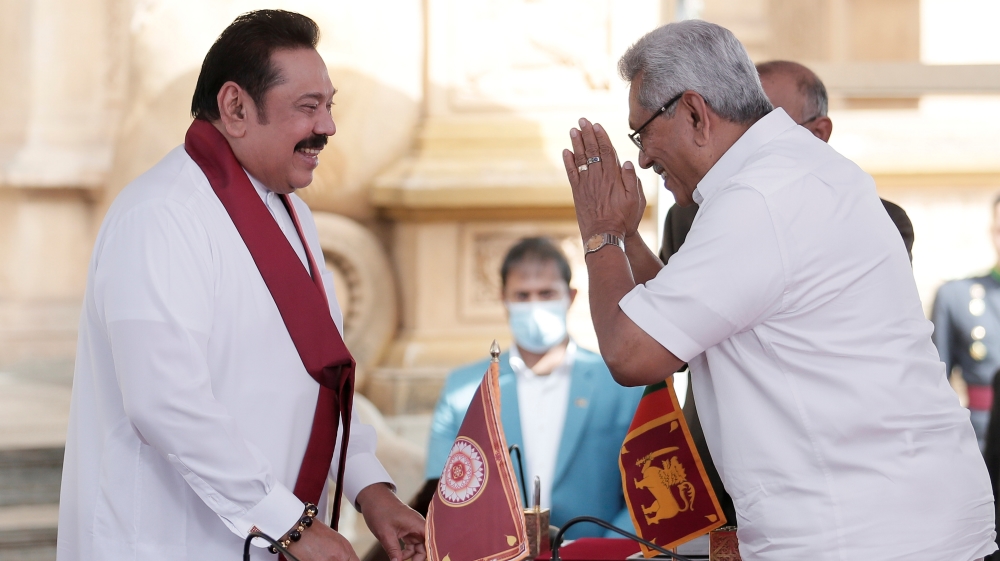 Sri Lanka''s former leader Mahinda Rajapaksa and his brother, and Sri Lanka''s President Gotabaya Rajapaksa gesture during the swearing in ceremony at Kelaniya Buddhist temple in Colombo
