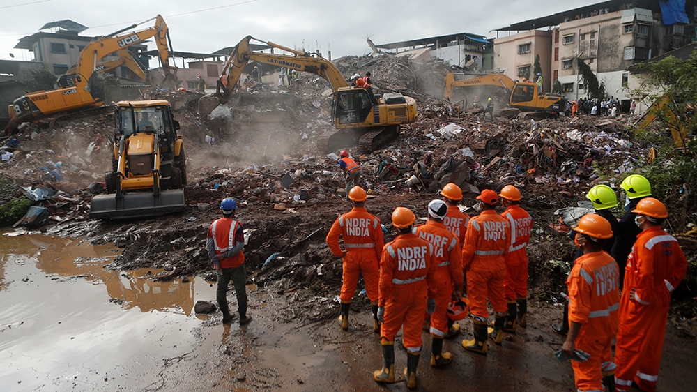 Rescue workers search for survivors in the debris after a five-story building collapsed in Mahad in Raigad district in the western state of Maharashtra, India, August 25, 2020. REUTERS/Francis Mascare