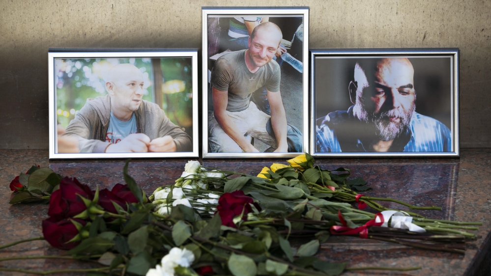 Flowers are placed by portraits of slain journalists Alexander Rastorguyev, Kirill Radchenko and Orkhan Dzhemal,