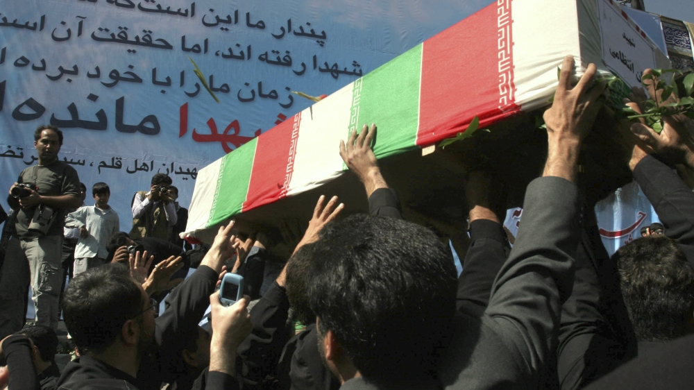 Men carry the coffin of a woman, a victim of mosque explosion, during funeral in Shiraz