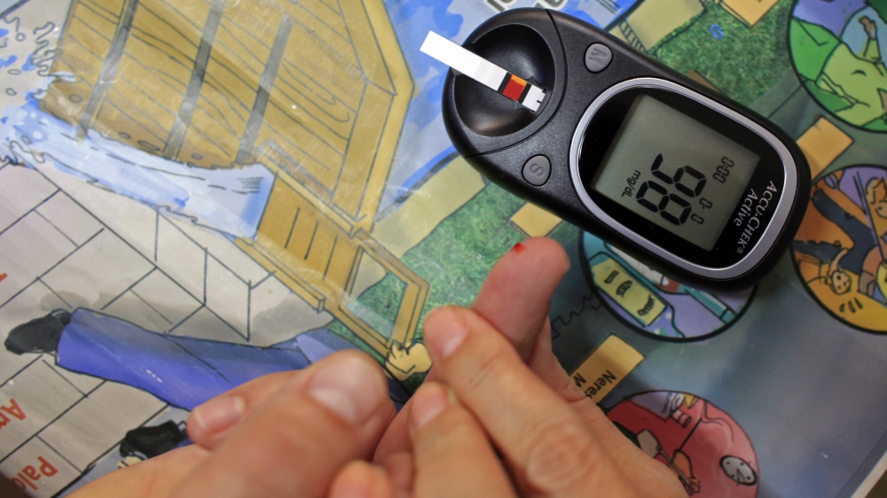 Diabetes educator Cristofor teaches how to perform a blood sugar test at the Nicolae Paulescu National Institute for Diabetes, Nutrition and Metabolic Diseases in Bucharest