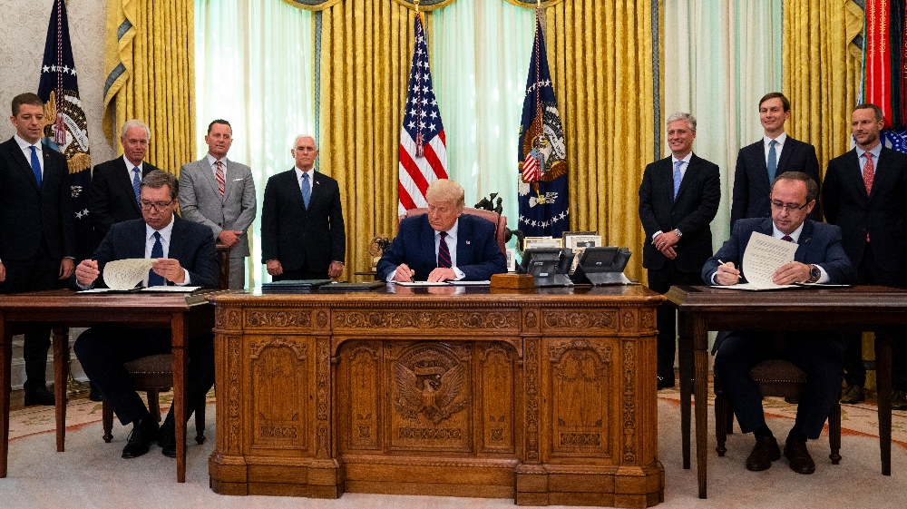 President Donald Trump participates in a signing ceremony with Serbian President Aleksandar Vucic, left, and Kosovar Prime Minister Avdullah Hoti, in the Oval Office of the White House,