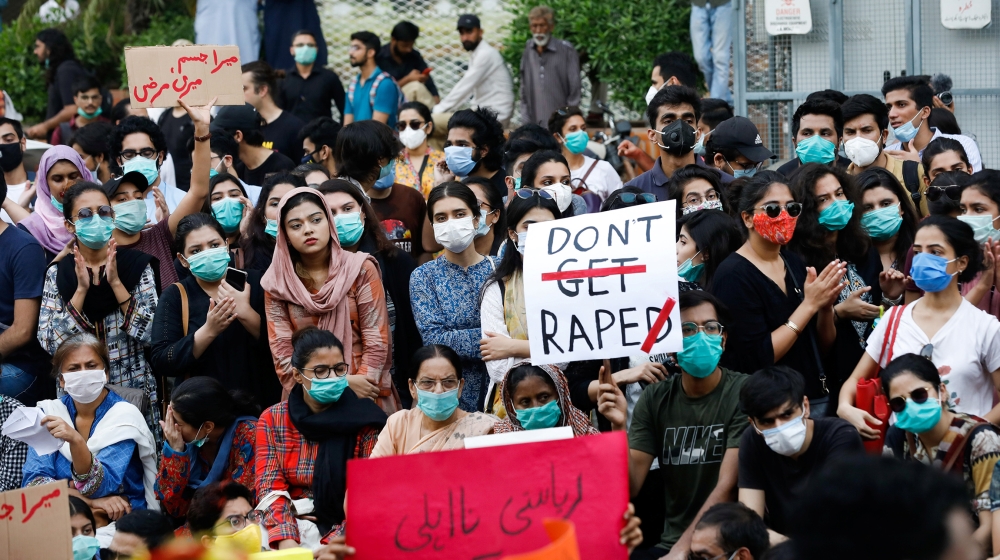 People carry signs against a gang rape that occurred along a highway and to condemn violence against women and girls, during a protest in Karachi, Pakistan September 12, 2020. REUTERS/Akhtar Soomro