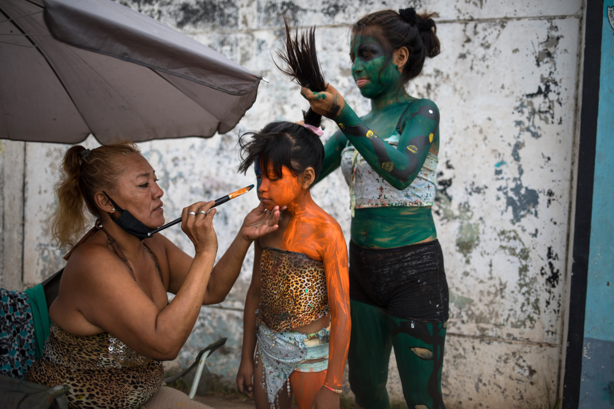 Art professor Iveri Sanchez and her students ready for their Amazonian street dances which they perform at a traffic light in hopes of receiving tips from the drivers, in the Shipibo Indigenous commun